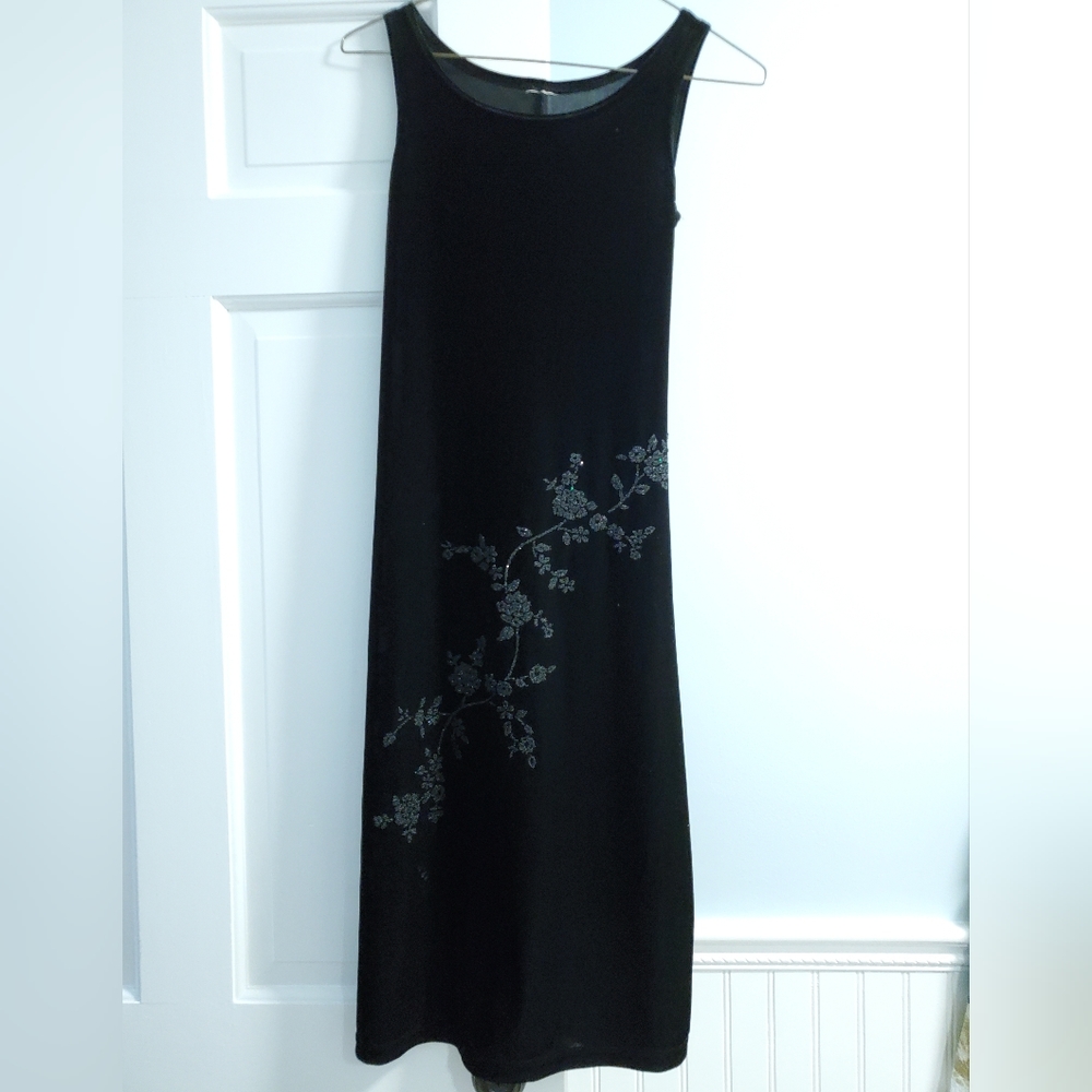 Small, black pull-over dress with beading.